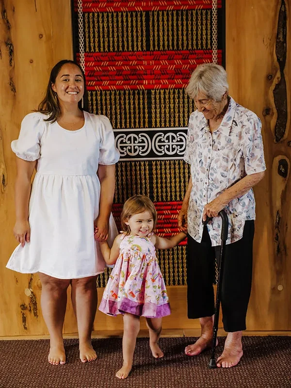 Ngāti Pūkenga Iwi, Whanau standing in front of a tukutuku panel